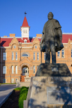 Provo, UT, USA - June 10, 2024; Statue of Brigham Young by Dee Jay Bawden in Academy Square with library