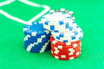 Dice with a winning combination in poker on a black table and chips in the background. Poker Chips on a gaming table