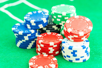 Dice with a winning combination in poker on a black table and chips in the background. Poker Chips on a gaming table