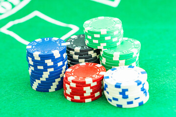 Dice with a winning combination in poker on a black table and chips in the background. Poker Chips on a gaming table