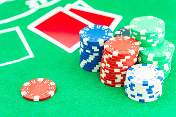 Dice with a winning combination in poker on a black table and chips in the background. Poker Chips on a gaming table