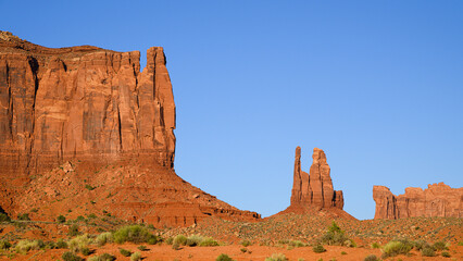 Naklejka premium Brigham's Tomb and The King and His Throne sandstone landscape features in Monument Valley