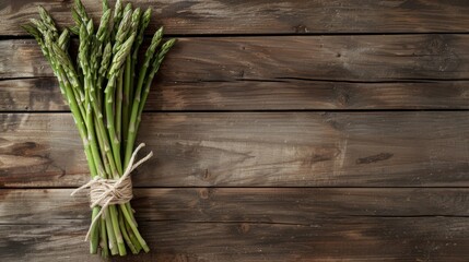 Asparagus bunch with string bow on wooden background