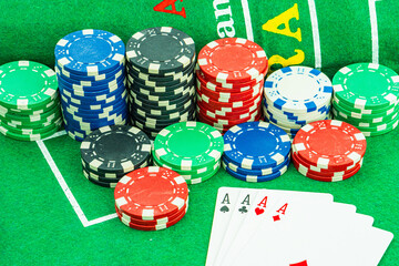Background with cards chips and dices for playing casino gambling on green felt mat and green isolated background Front view.