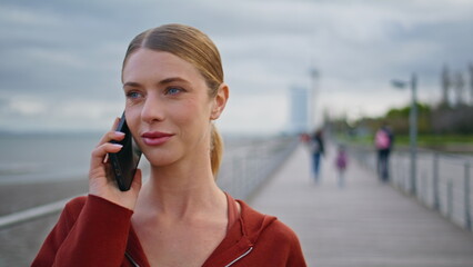 Walking lady talking mobile phone closeup. Relaxed sportswoman have conversation