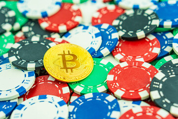 Bitcoin gold coin on the poker table with chips.