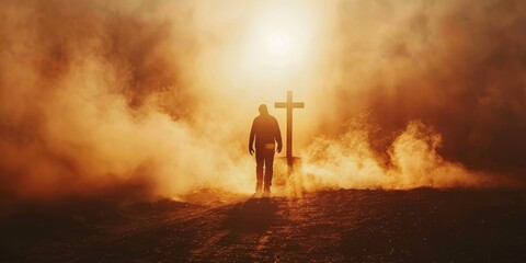 Fototapeta premium Silhouette of a man in the desert with a cross in the smoke and dust under the sun. Silhouette of a man in the desert with a cross in the smoke and dust under the sun