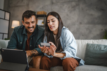 Adult caucasian couple buy online on digital tablet with credit card