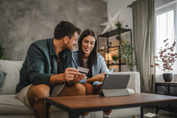 Adult caucasian couple buy online on digital tablet with credit card