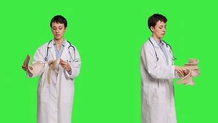 Orthopedics specialist holding a cervical neck collar against greenscreen backdrop, medical foam tool helping with fractures and physical therapy. Medic uses brace for accident trauma. Camera B.