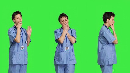 Medical assistant feeling extremely sleepy against greenscreen backdrop, being overworked after the...
