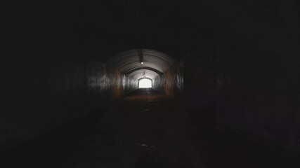 Running walking through dark tunnel at night, danger, escape, first person view pov