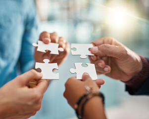 Business people, puzzle and hands with teamwork, cooperation and partnership for project, merger...
