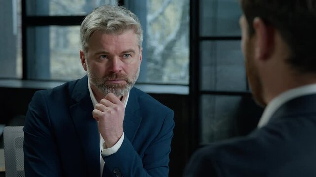 Two Caucasian men businessmen partners communicate at business meeting in office man bank manager insurance agent consulting client employer hr hiring recruit at job interview partnership recruitment