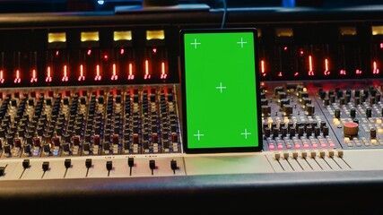 Professional audio expert mixing and mastering tracks in music production studio, pushing buttons...