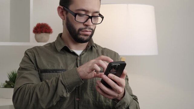 Man writing a message on his cell phone