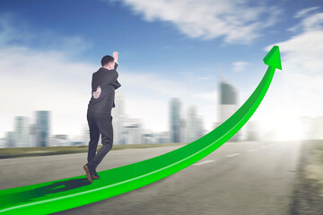 Fototapeta premium Rear view of male manager running fast on the upward arrow on the road