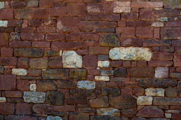 Brick background in Collonges-la-Rouge village, one of the most beautiful villages in France with houses made from red stones, tourists destination in Dordogne