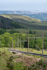 Fototapeta premium Travelling by old wooden train up to Larrun or La Rhune, Larhune mountain at the western end of the Pyrenees located on border of France and Spain, in traditional Basque provinces Labourd and Navarra