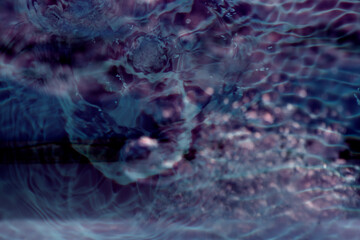 Black water waves on the surface ripples blurred. Defocus blurred transparent blue colored clear calm water surface texture with splash and bubbles. Water waves with shining pattern texture background