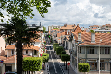 Fototapeta premium Walking in Arcachon, vacation destination town on Atlantic coast with beatiful parks, villas, streets and sandy beach, France