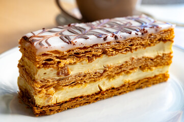 Portion of french mille-feuille cake, vanilla or custard slice, Napoleon puff pastry layered with pastry cream in bakery