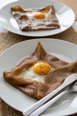 Galettes pancakes from Brittany made with buckwheat flour and served with savoury toppings, smelted cheese and eggs