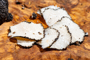 Slices of Italian black summer truffle, tasty aromatic mushroom, close up