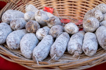 Obraz premium Variety of homemade dried salami sausages in French butchery shop, Dordogne, France, meat food background close up