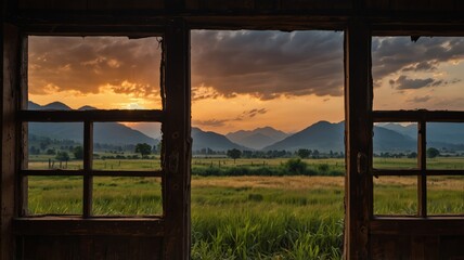 Inside out view of an old wooden door, mountains with grass and sunset in the background.