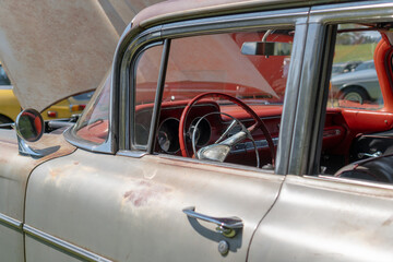 Tight close-up shot of a vintage automobile at a local car show.