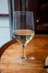Glass of txakoli or chacolí slightly sparkling very dry white wine produced in Spanish Basque Country in typical pinchos bar in old part of San Sebastian or Donostia, Spain