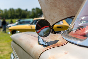Tight close-up shot of a vintage automobile at a local car show.