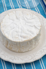 French soft Camembert cheese, original Camembert de Normandie, close up with white mold