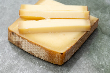 French cheese Comte, varieties unpasteurised ed milk Prestige, fruity flavoured Fruite and Vieille Reserve close up