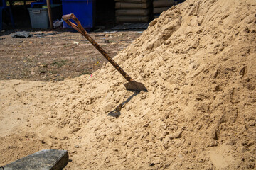 Shovels planted in the sandy soil to prepare for construction.