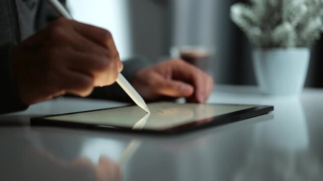 person using a stylus on a tablet, highlighting the blend of human creativity and digital technology. It represents modern digital drawing, writing, and designing methods in the creative process.