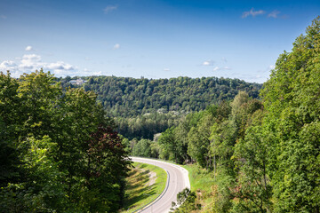 Panorama of Scenic Road Through Vidzeme Hills in Latvia taken in Sigulda with a path passing by. Vidzeme is the northern and eastern land of latvia.