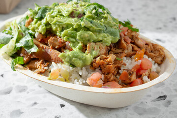 A closeup view of a burrito bowl.