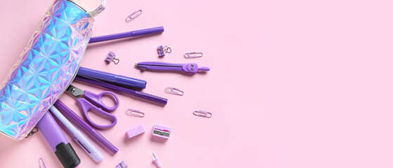 Silver pencil case with different stationery on pink background. Top view