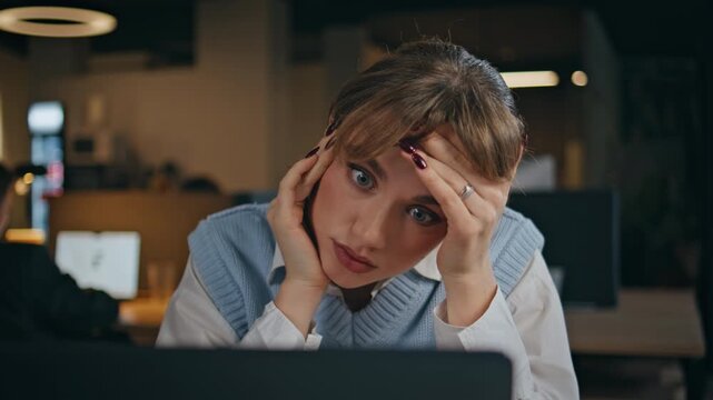 Exhausted office worker overworking at office late evening closeup. Tired woman