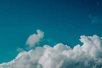 White clouds in a blue sky. Heaven background. Beautiful heavenly wallpaper in blue tones.stunning celestial wallpaper in shades of blue.