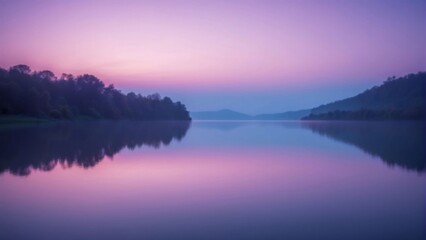 Fototapeta premium A tranquil lake scene with a blurred background of trees and a pink sunset reflected in the water, copy space