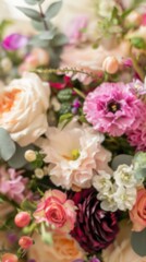 A soft, out-of-focus image of a bouquet of pink, white, and peach flowers