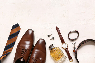 Set of male accessories with shoes, perfume and wrist watch on white grunge background. Top view