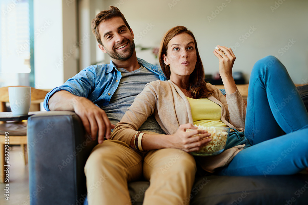 Sticker Couple, happy and relax on sofa with popcorn, funny movie and comedy show at home. Woman, man or shocked on couch for plot twist, popular television series or relationship development in living room