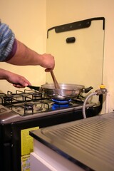 an arm of a person stirring food