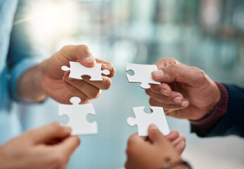 Business people, puzzle and hands with teamwork, planning and cooperation for project, merger or...