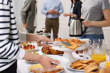 Coworkers having business lunch in restaurant, closeup