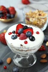 Tasty yogurt with fresh berries on table, closeup
